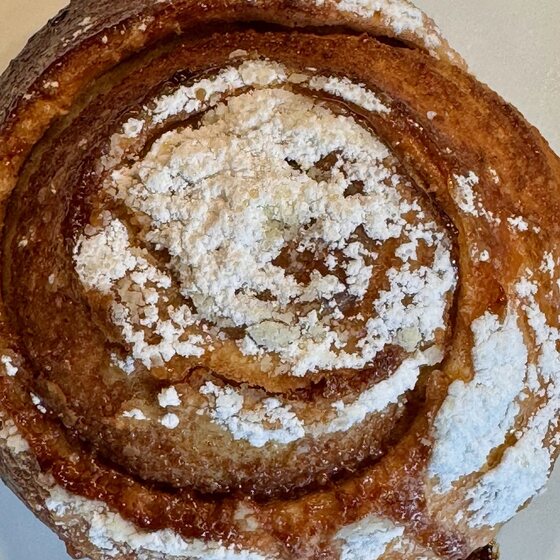 Zimtschnecke Nr. 2 von oben: dunkel gebacken, mit Puderzucker bestäubt